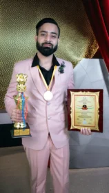 Dr Gaurav Saxena holding the Bharat Book of World Records certificate for Bharat Excellence Award 2025, highlighting his recognition in astrology, numerology, vastu healing, and professional achievements in India.