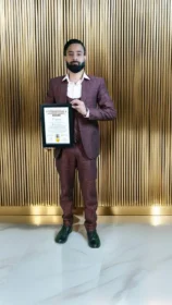 Dr Gaurav Saxena holding International Achievers Award 2025 certificate for excellence in astrology numerology vastu spiritual leadership