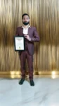 Dr Gaurav Saxena holding International Achievers Award 2025 certificate for excellence in astrology numerology vastu spiritual leadership