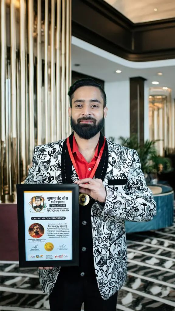 Dr Gaurav Saxena holding Subhash Chandra Bose National Award 2025 certificate and medal for excellence in astrology and spiritual leadership